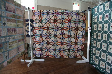 The quilt on the left is "Color Weave" by Beverly Crane, Pine River and the quilt on the right which won the People's Choice Award and the Award of Excellence for bed quilts was "Wedding Star" by Sharina Adams, Phelps.